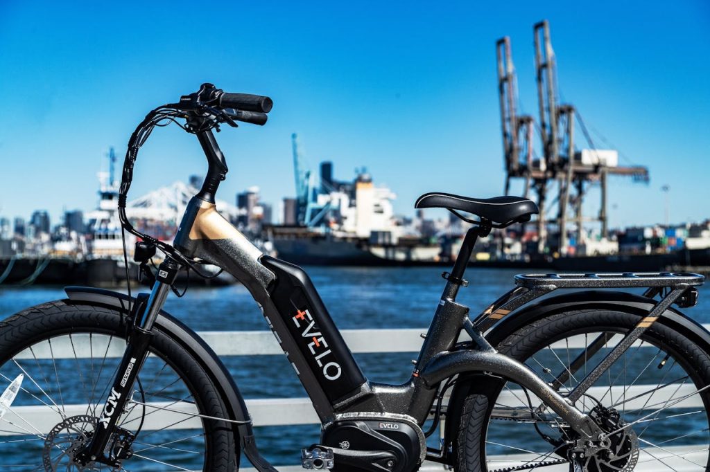 Evelo electric bike parked by the Seattle waterfront cityscape.